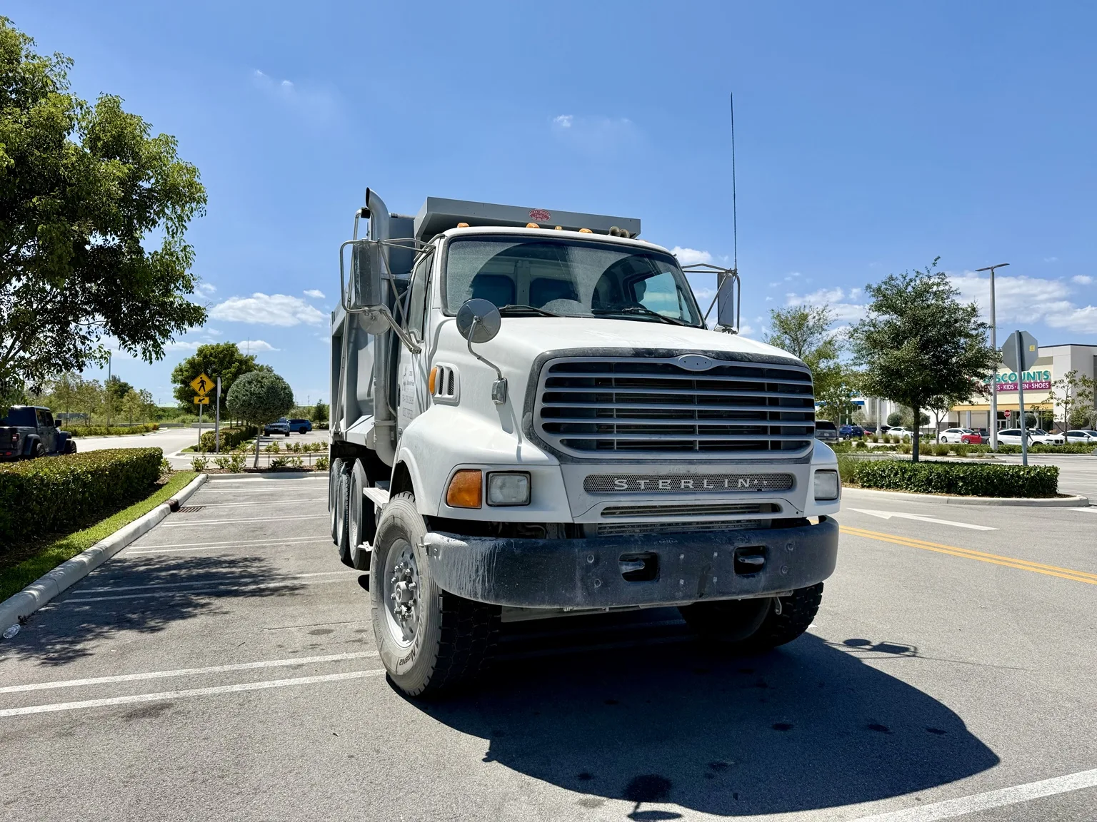 Front view of the white JDG dump truck