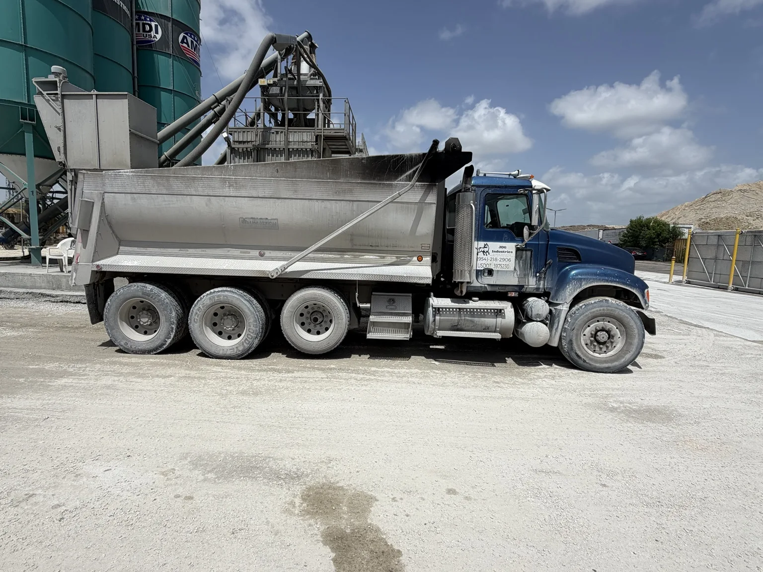 JDG dump truck at a material loading facility